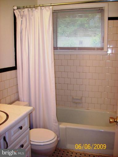 8208 Edwill Avenue Rosedale, MD 21237 - Photo 13 of 18 a bathroom with a granite countertop bathtub toilet and sink