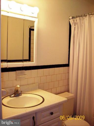 8208 Edwill Avenue Rosedale, MD 21237 - Photo 14 of 18 a bathroom with a sink and a mirror