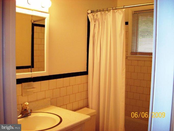 8208 Edwill Avenue Rosedale, MD 21237 - Photo 15 of 18 a bathroom with a sink toilet and shower