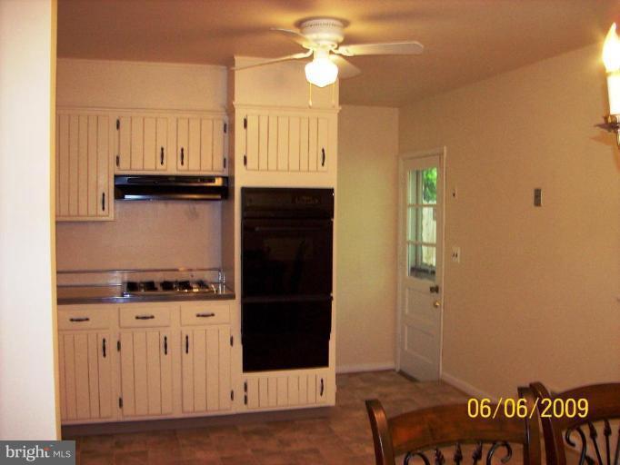 8208 Edwill Avenue Rosedale, MD 21237 - Photo 9 of 18 a kitchen with cabinets and a stove top oven