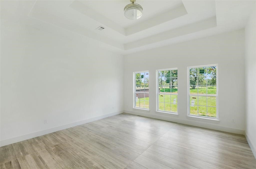 2291 Riverside Drive West Columbia, TX 77486 - Photo 37 of 50 an empty room with wooden floor and windows