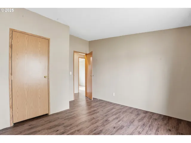 a view of an empty room and wooden floor