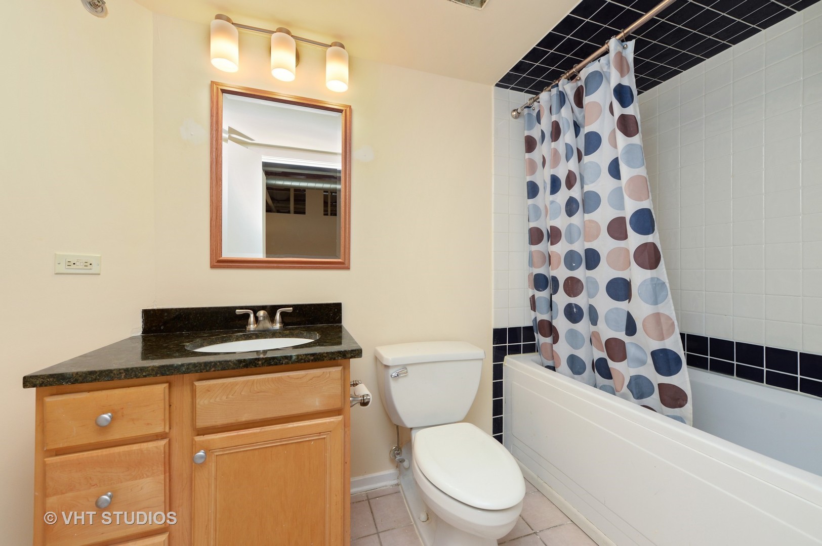 500 South Clinton Street, Unit 542 Chicago, IL 60607 - Photo 12 of 14 a bathroom with a granite countertop toilet a sink and a shower