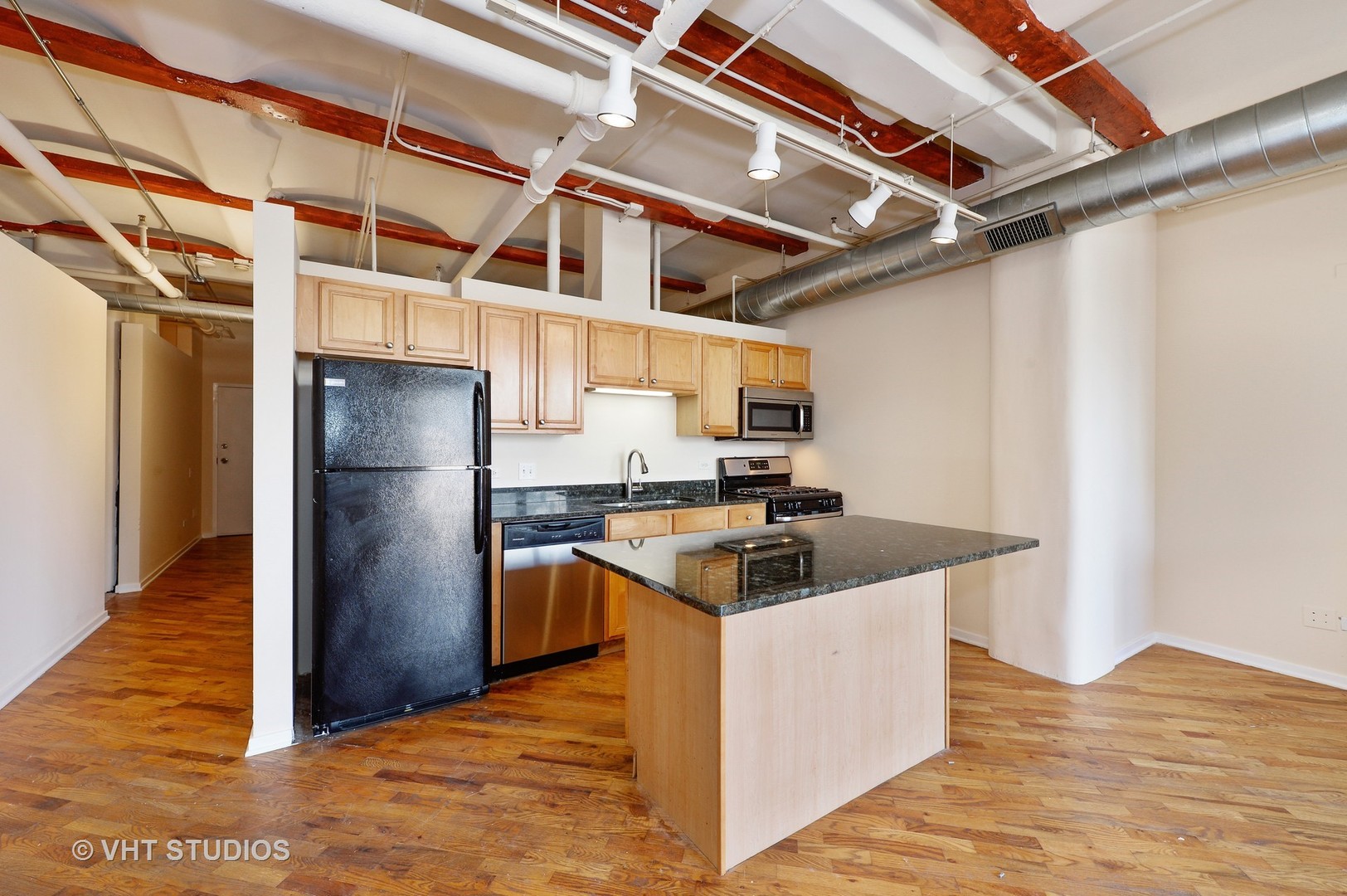 500 South Clinton Street, Unit 542 Chicago, IL 60607 - Photo 5 of 14 a kitchen with stainless steel appliances granite countertop a sink and a refrigerator