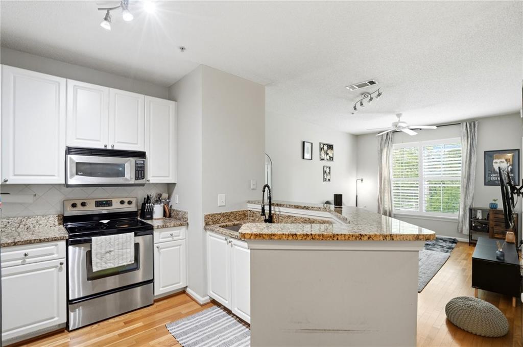 10 Perimeter Summit Boulevard, Unit 1204 Atlanta, GA 30319 - Photo 1 of 39 a kitchen with stainless steel appliances granite countertop a sink a stove and cabinets