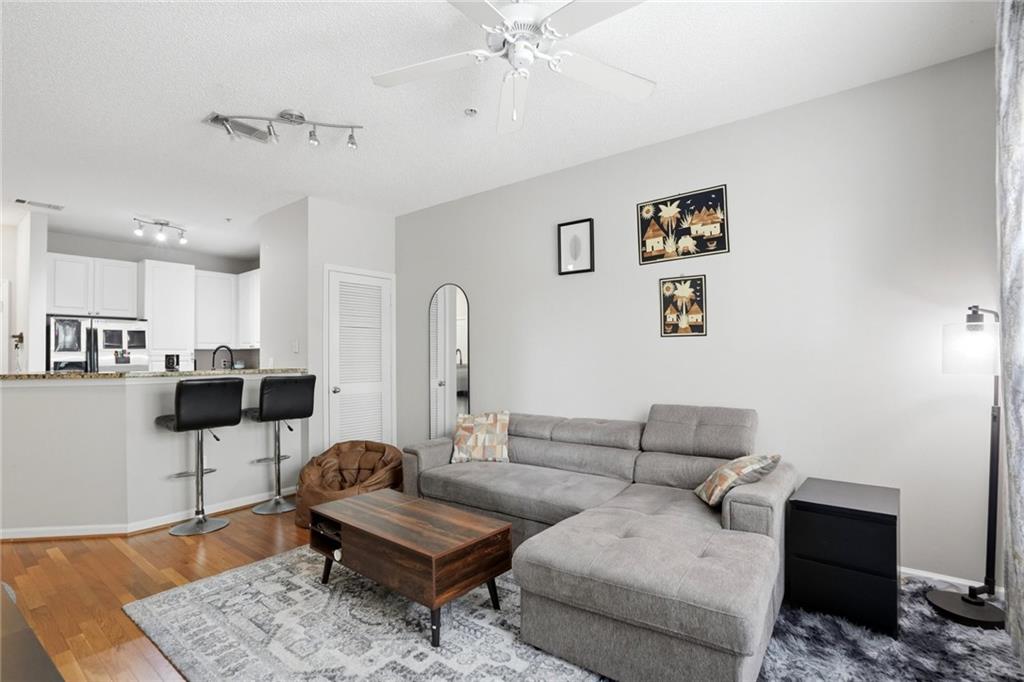10 Perimeter Summit Boulevard, Unit 1204 Atlanta, GA 30319 - Photo 11 of 39 a living room with furniture and a rug