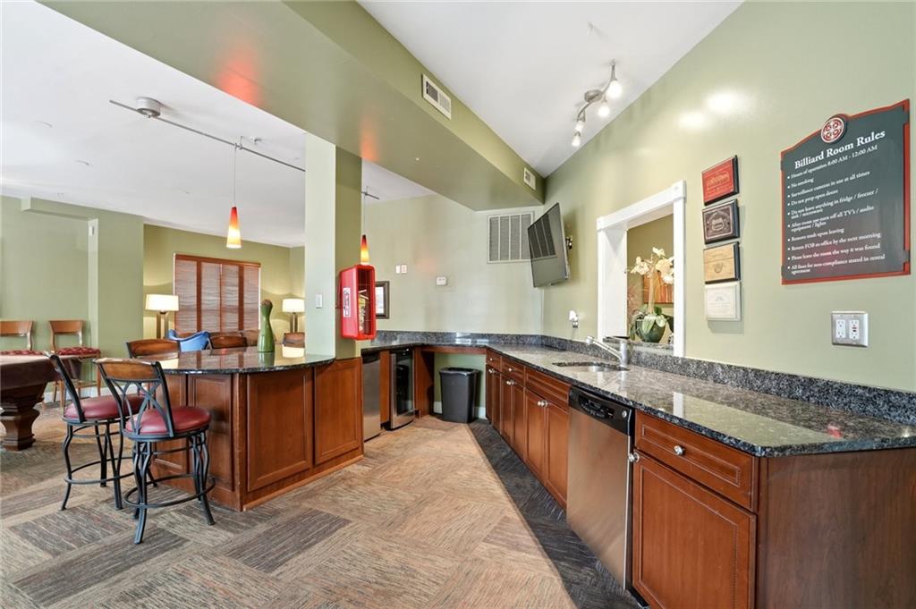 10 Perimeter Summit Boulevard, Unit 1204 Atlanta, GA 30319 - Photo 15 of 39 a large kitchen with lots of counter space and furniture