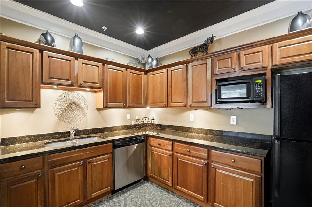 10 Perimeter Summit Boulevard, Unit 1204 Atlanta, GA 30319 - Photo 19 of 39 a kitchen with stainless steel appliances granite countertop a sink and cabinets