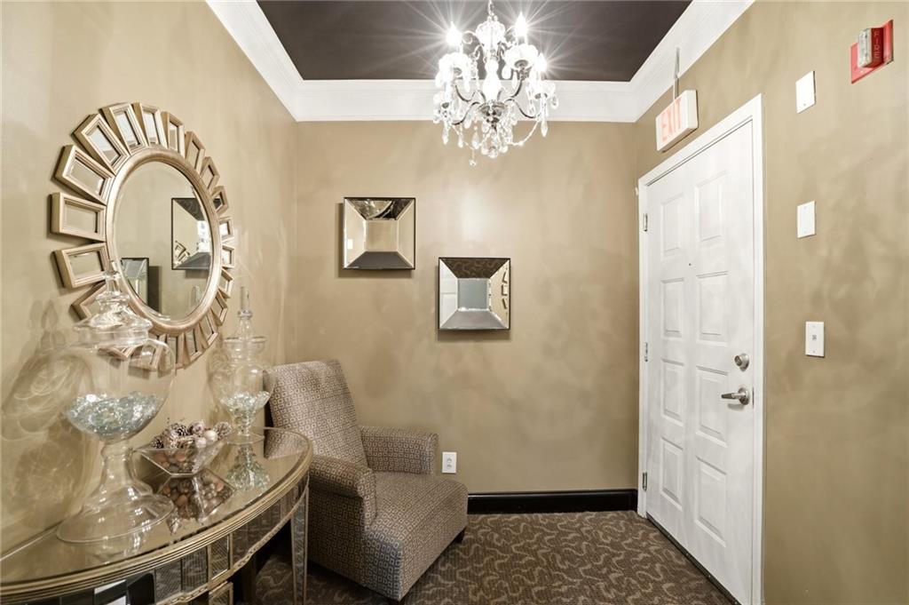 10 Perimeter Summit Boulevard, Unit 1204 Atlanta, GA 30319 - Photo 21 of 39 a view of a livingroom with wooden floor and a chandelier