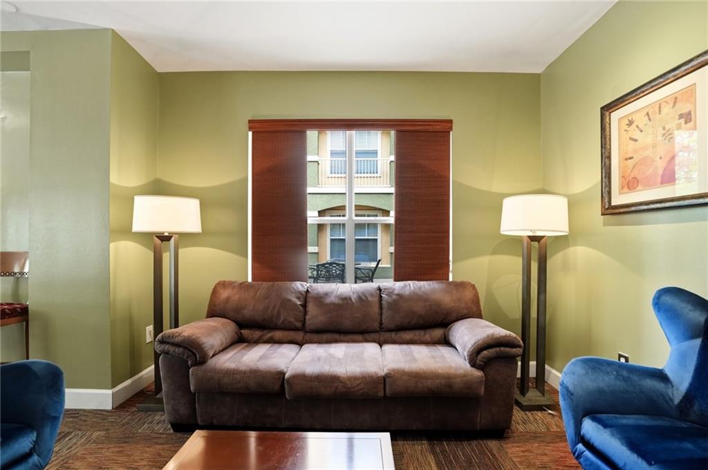 10 Perimeter Summit Boulevard, Unit 1204 Atlanta, GA 30319 - Photo 25 of 39 a living room with furniture and a window