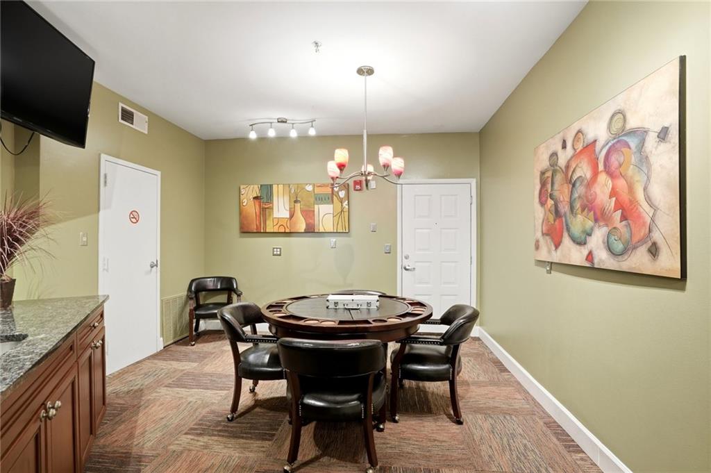 10 Perimeter Summit Boulevard, Unit 1204 Atlanta, GA 30319 - Photo 27 of 39 a view of a dining room with furniture and wooden floor