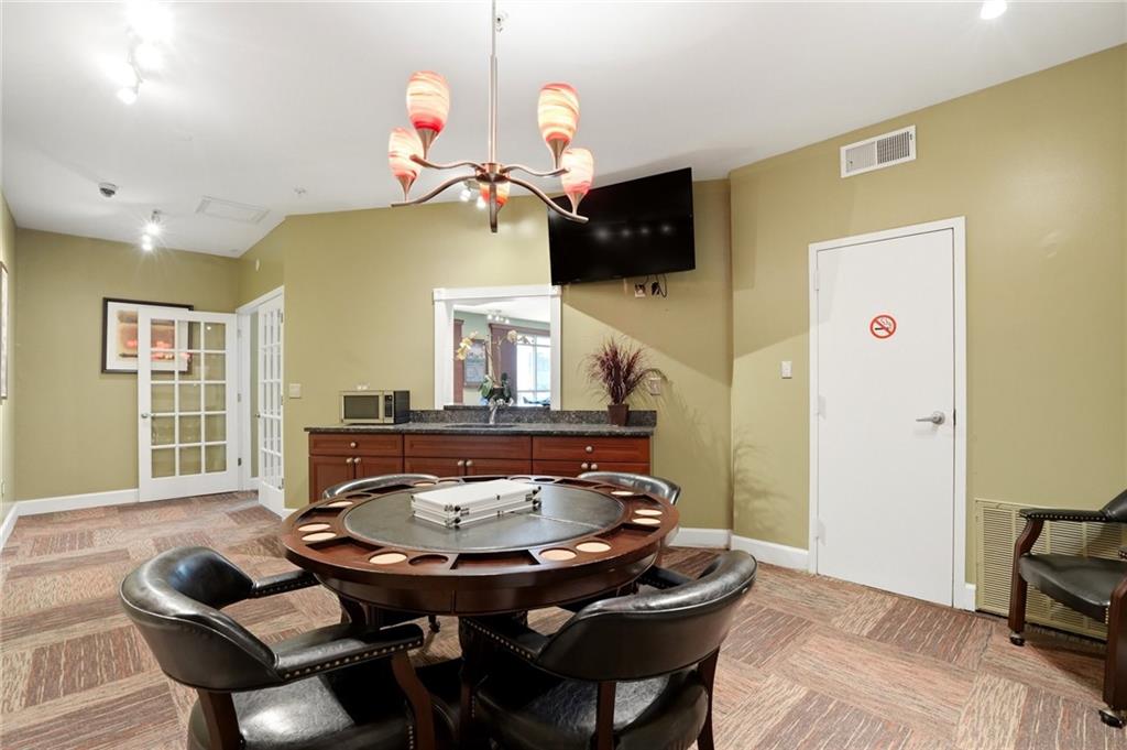 10 Perimeter Summit Boulevard, Unit 1204 Atlanta, GA 30319 - Photo 28 of 39 a living room with furniture and wooden floor