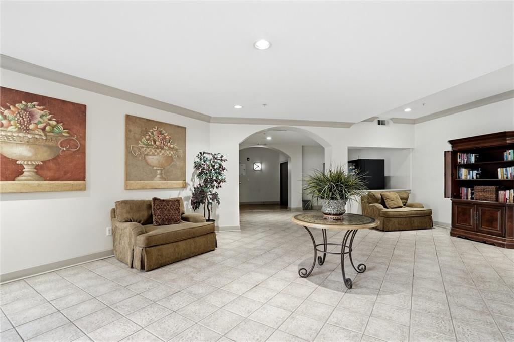 10 Perimeter Summit Boulevard, Unit 1204 Atlanta, GA 30319 - Photo 30 of 39 a living room with furniture and a potted plant
