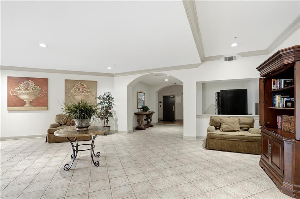 10 Perimeter Summit Boulevard, Unit 1204 Atlanta, GA 30319 - Photo 31 of 39 a living room with furniture and a flat screen tv