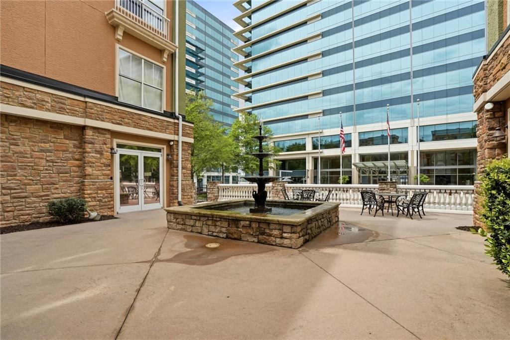 10 Perimeter Summit Boulevard, Unit 1204 Atlanta, GA 30319 - Photo 36 of 39 a view of a patio with a table and chairs and potted plants