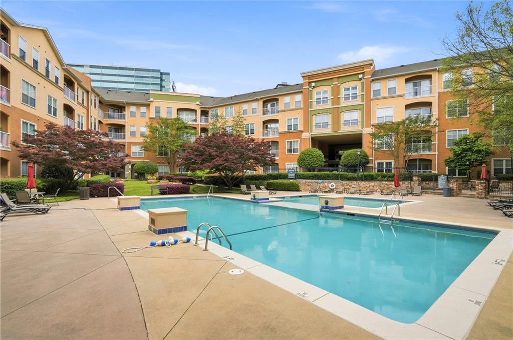 10 Perimeter Summit Boulevard, Unit 1204 Atlanta, GA 30319 - Photo 39 of 39 a view of a building with a swimming pool and a chairs