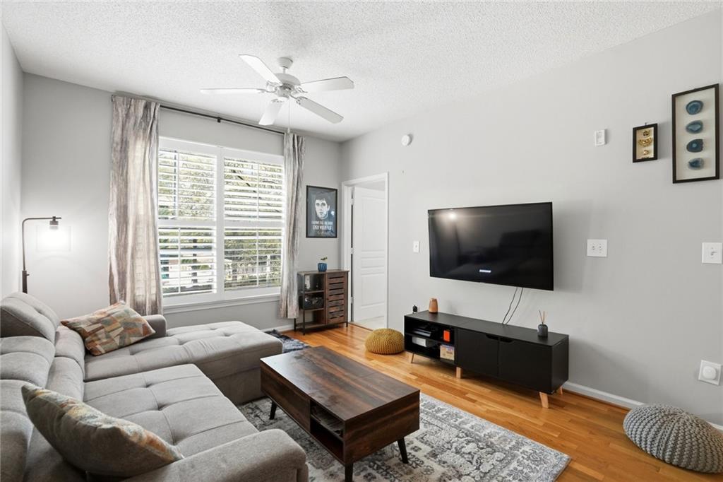 10 Perimeter Summit Boulevard, Unit 1204 Atlanta, GA 30319 - Photo 9 of 39 a living room with furniture and a flat screen tv