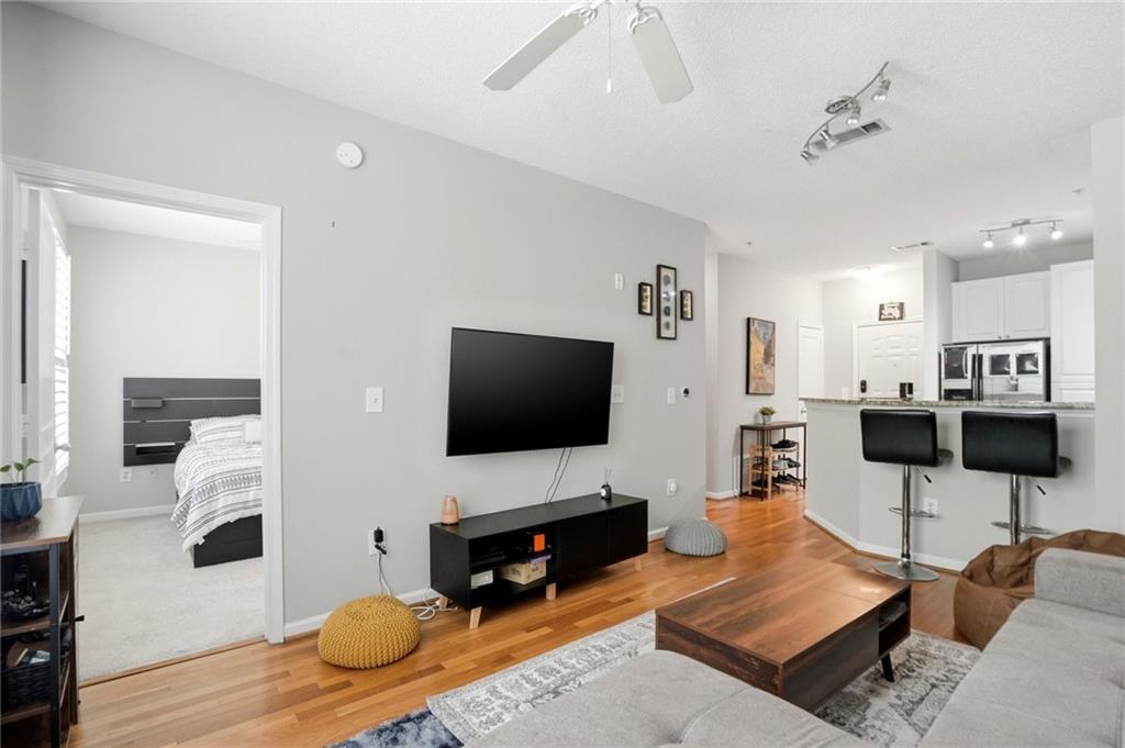 10 Perimeter Summit Boulevard, Unit 1204 Atlanta, GA 30319 - Photo 10 of 39 a living room with furniture and a flat screen tv