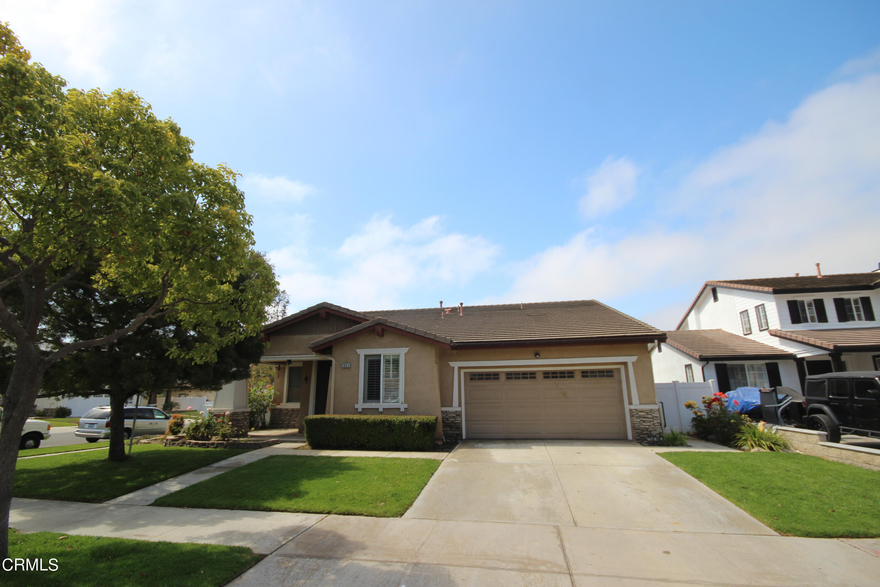1034 Caliente Way Oxnard, CA 93036 - Photo 1 of 12 a front view of house with yard and green space