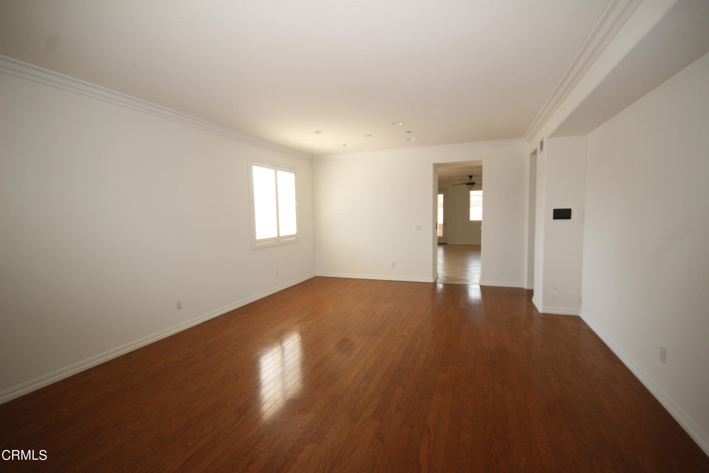 1034 Caliente Way Oxnard, CA 93036 - Photo 10 of 12 an empty room with wooden floor and windows