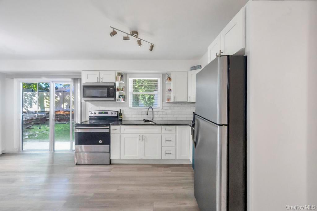382 Boyle Road Selden, NY 11784 - Photo 18 of 26 a kitchen with stainless steel appliances a refrigerator sink and microwave