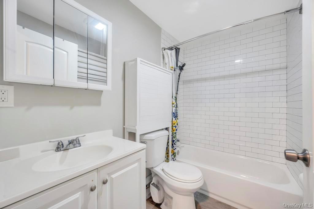 382 Boyle Road Selden, NY 11784 - Photo 19 of 26 a bathroom with a sink toilet and shower