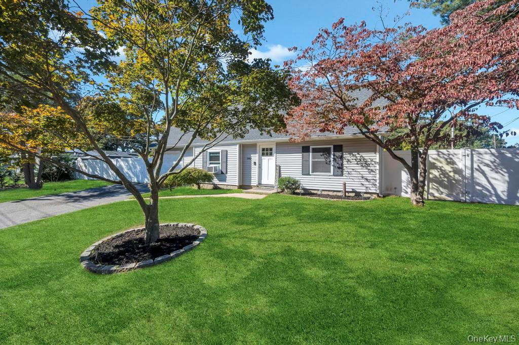 382 Boyle Road Selden, NY 11784 - Photo 2 of 26 a front view of a house with a garden