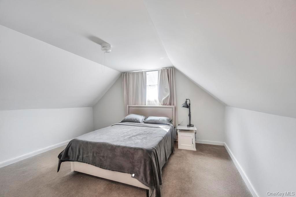 382 Boyle Road Selden, NY 11784 - Photo 23 of 26 a bedroom with a bed and a window