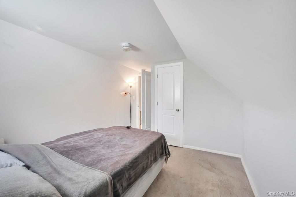 382 Boyle Road Selden, NY 11784 - Photo 24 of 26 a bedroom with a bed and a night stand