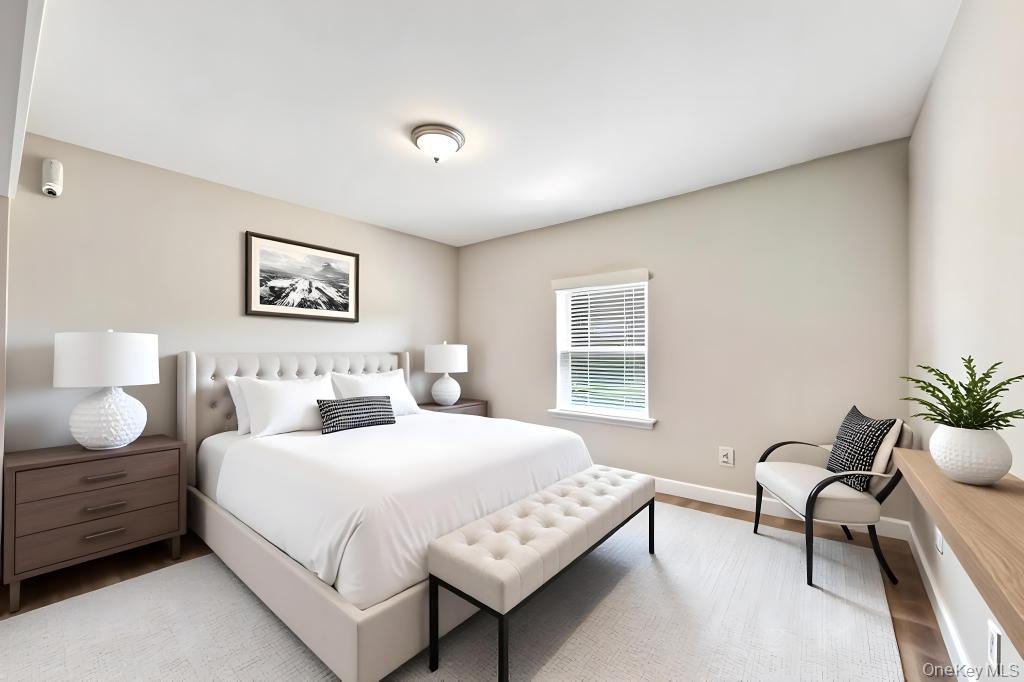 382 Boyle Road Selden, NY 11784 - Photo 25 of 26 a bedroom with a bed wooden floor and window