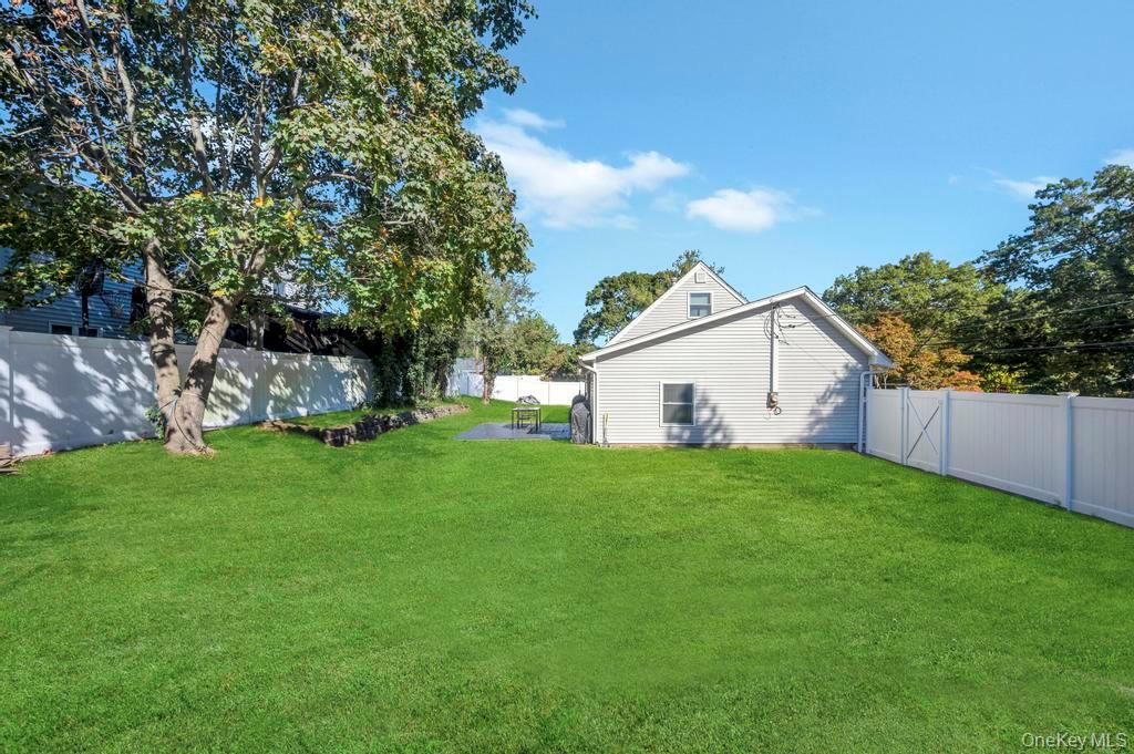 382 Boyle Road Selden, NY 11784 - Photo 5 of 26 a view of a backyard with plants and large trees