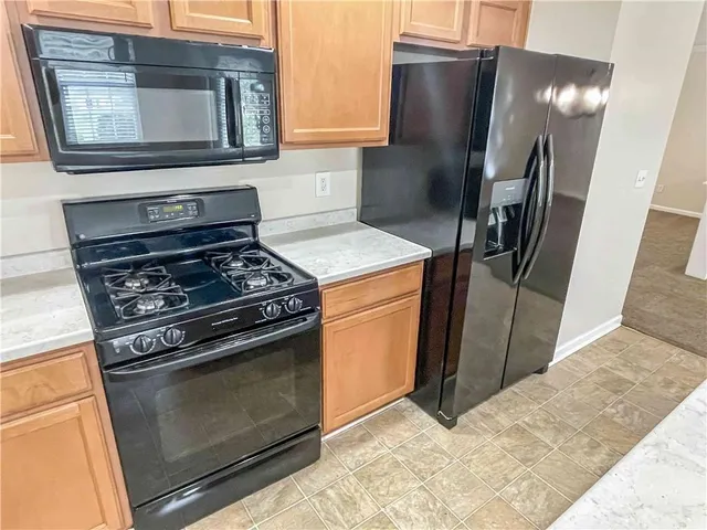a kitchen with stainless steel appliances granite countertop a stove and a refrigerator