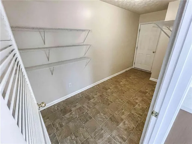 view of a room with wooden floor and white walls