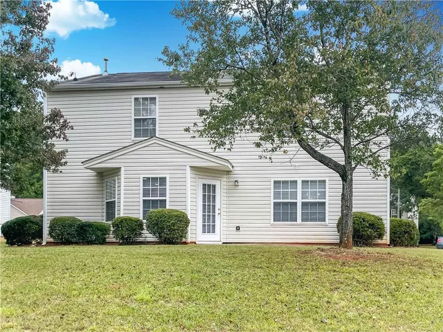 a view of yard with swimming pool and trees