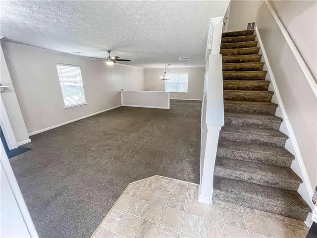 wooden floor in an empty room with a staircase