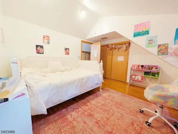 a bed room with a bed furniture and a large window