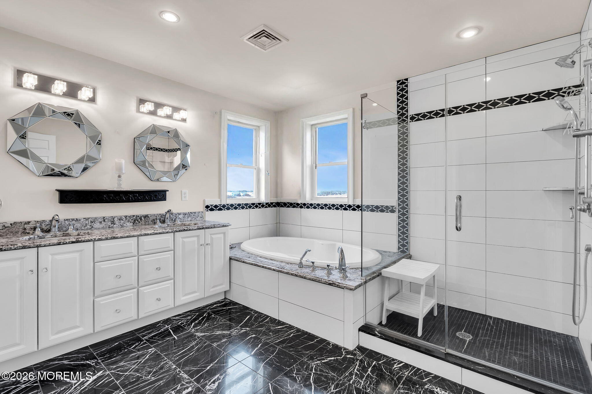385 Kingfisher Road Tuckerton, NJ 08087 - Photo 23 of 39 a bathroom with a double vanity sink a mirror and bathtub