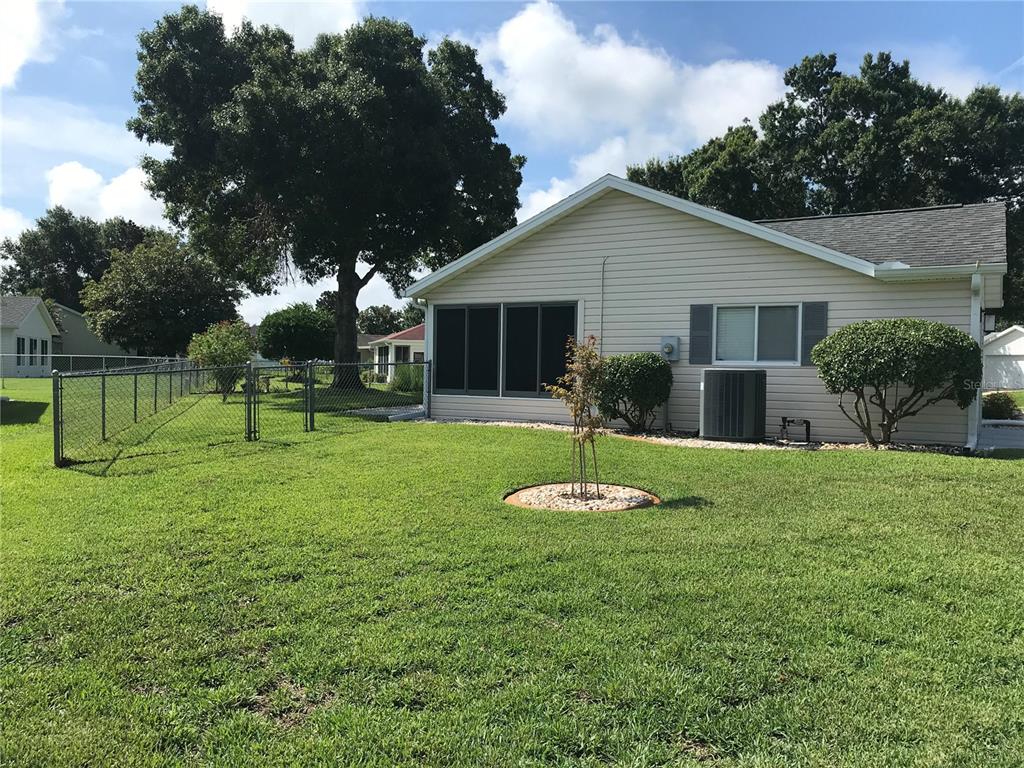 11879 Southwest 137th Loop Dunnellon, FL 34432 - Photo 4 of 37 a front view of house with a garden and trees