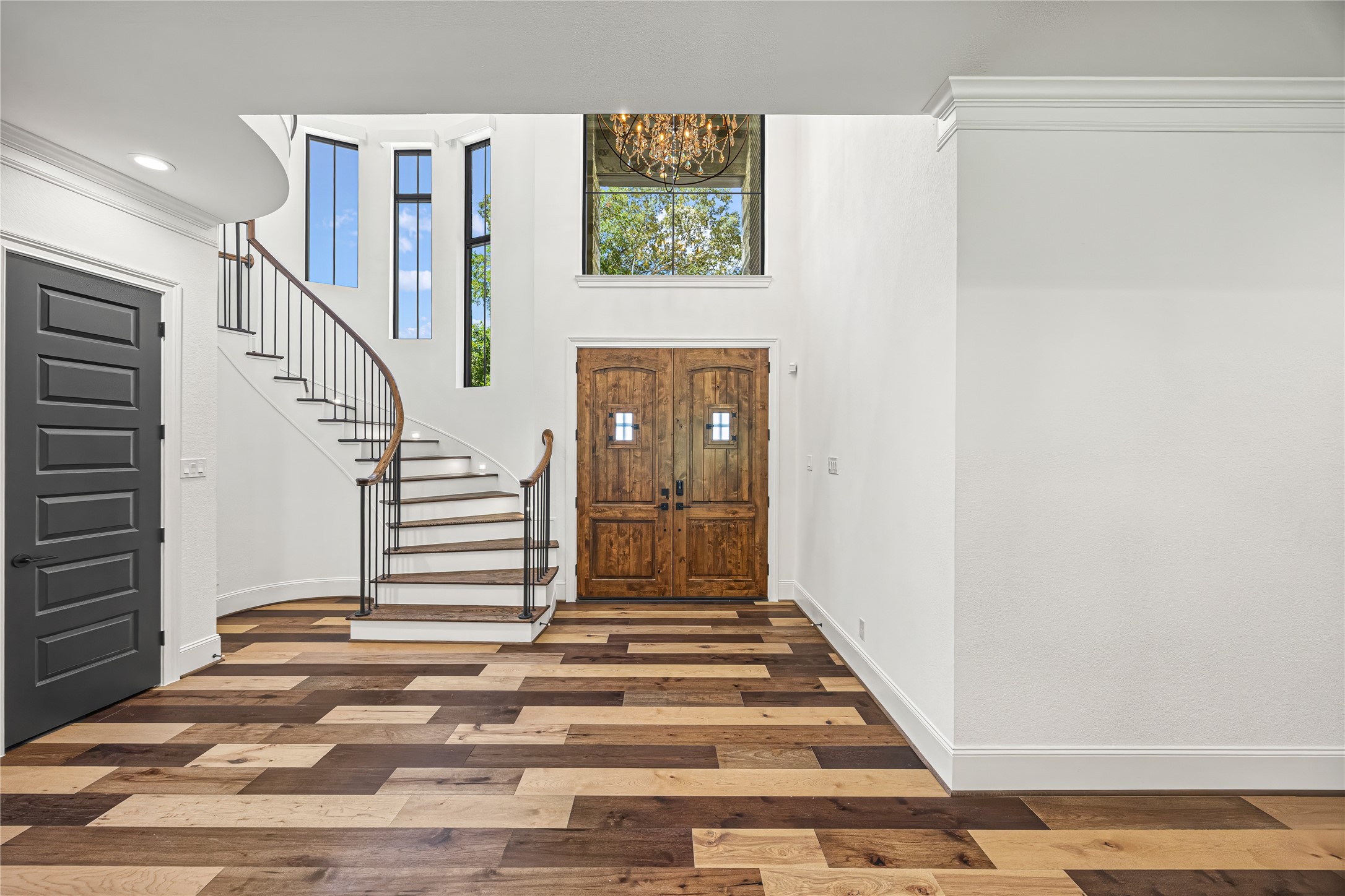 19314 Chateau Ridge Court Tomball, TX 77377 - Photo 3 of 50 Stunning grand entry with soaring ceilings, abundant natural light, custom doors, and an elegant curved staircase