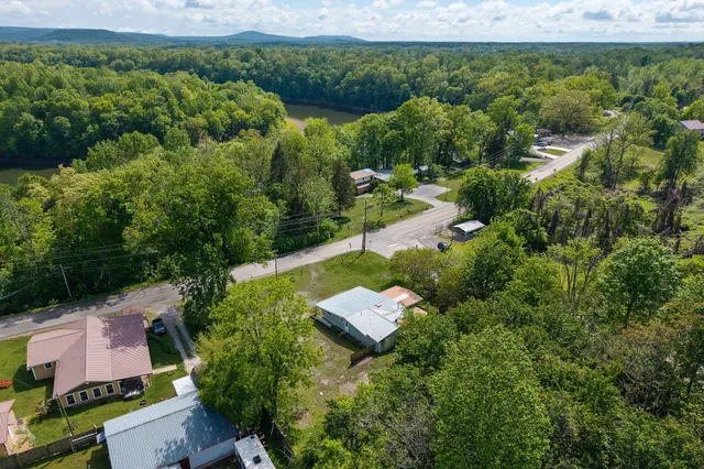 an aerial view of a house with a yard