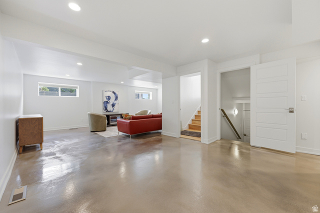 1389 Millbrook Way Bountiful, UT 84010 - Photo 50 of 74 Spacious lower level featuring polished concrete flooring, recessed lighting, white trim work, and multiple windows