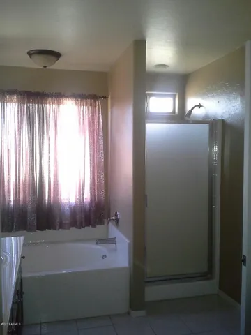 a bathroom with a bathtub and shower