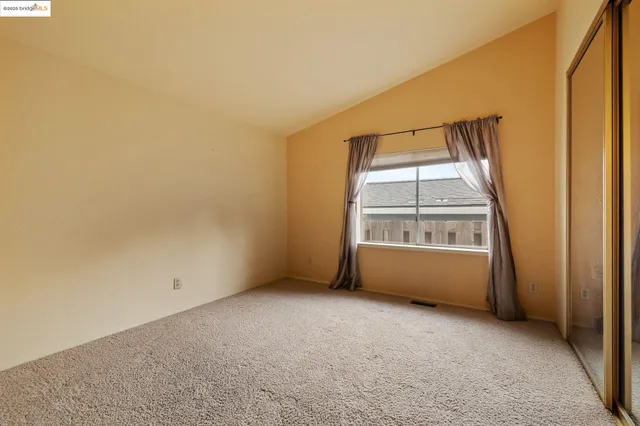 an empty room with a empty space and a window