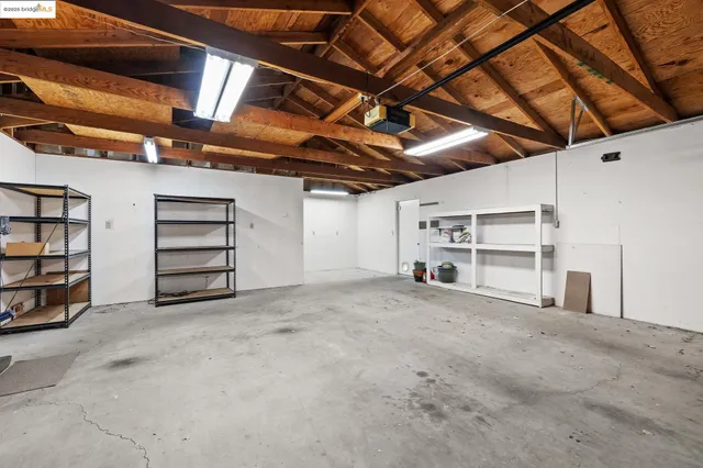 a view of an empty room with a book shelf