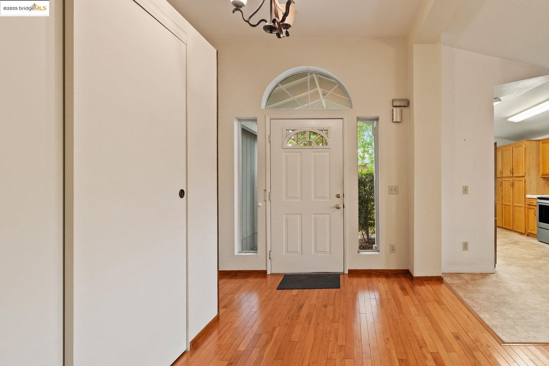 19560 River Birch Court, Unit 1 Sonora, CA 95370 - Photo 4 of 38 an empty room with wooden floor mirror and windows
