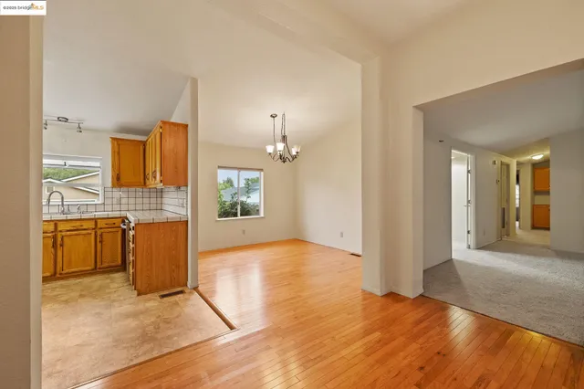 a view of a kitchen with a sink and a refrigerator