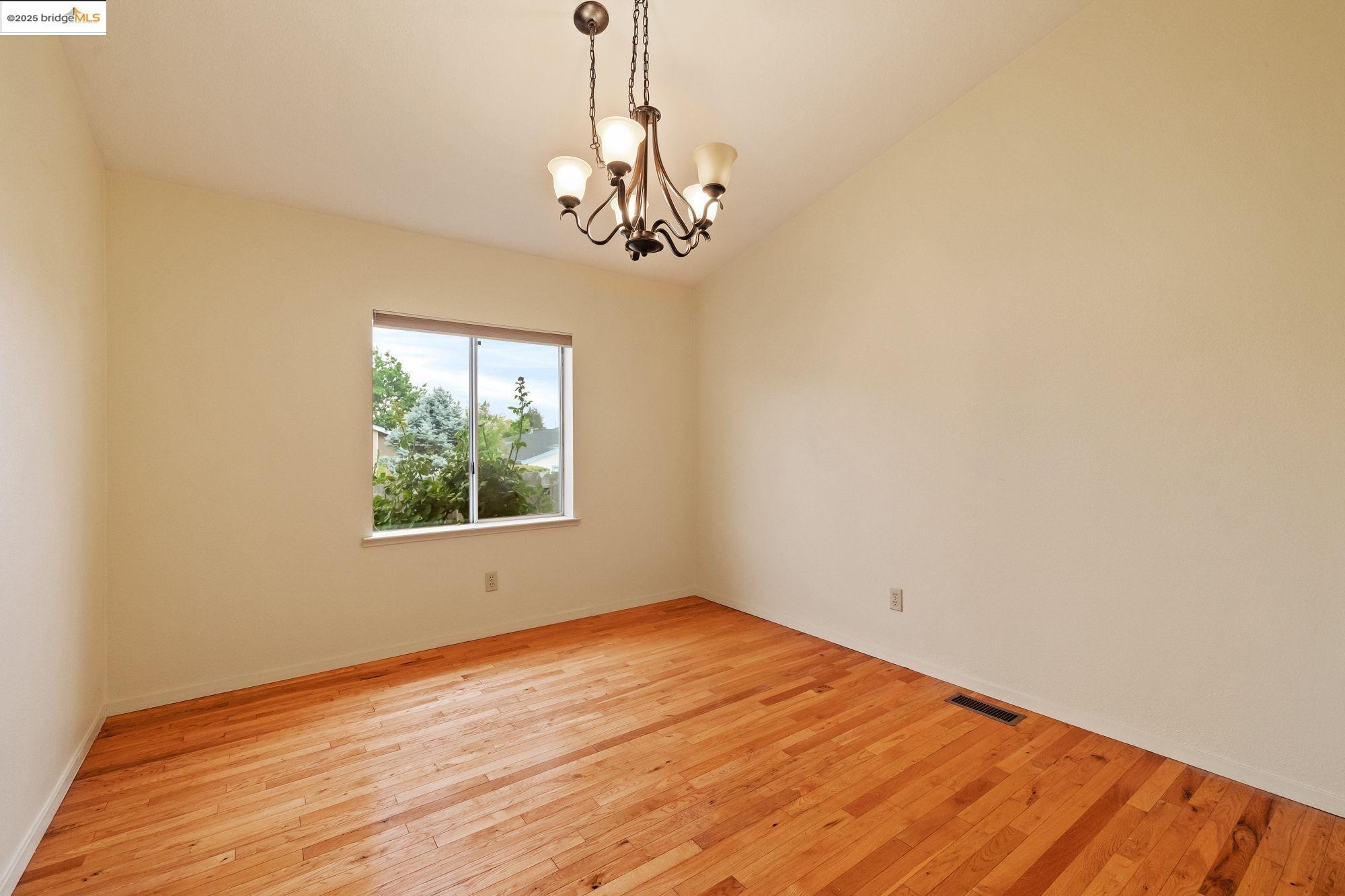 19560 River Birch Court, Unit 1 Sonora, CA 95370 - Photo 8 of 38 a view of an empty room with wooden floor and a window