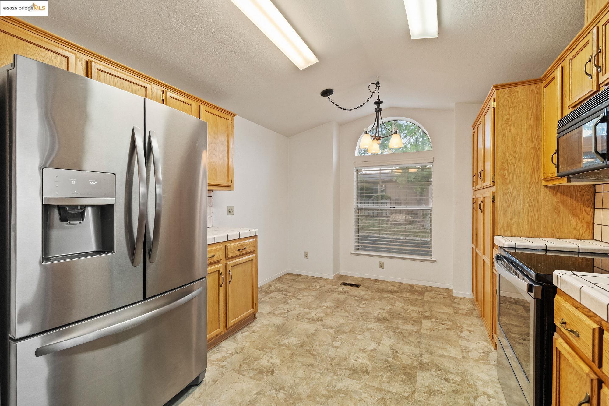 19560 River Birch Court, Unit 1 Sonora, CA 95370 - Photo 10 of 38 a kitchen with stainless steel appliances granite countertop a refrigerator a stove and a refrigerator