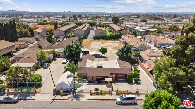 an aerial view of multiple houses with yard