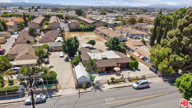 an aerial view of multiple houses with yard